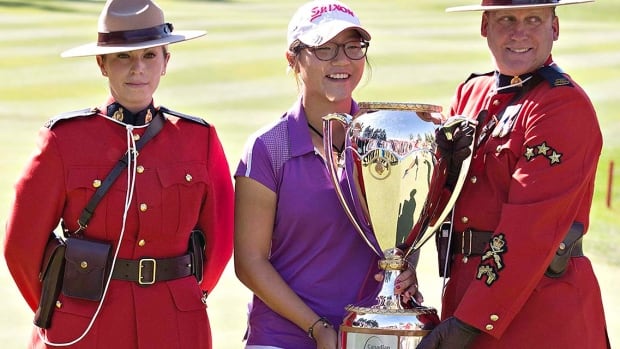 New Zealand women’s golfer Lydia Ko poses for a photo with the Royal Canadian Mounted Police after winning the LPGA Canadian Women