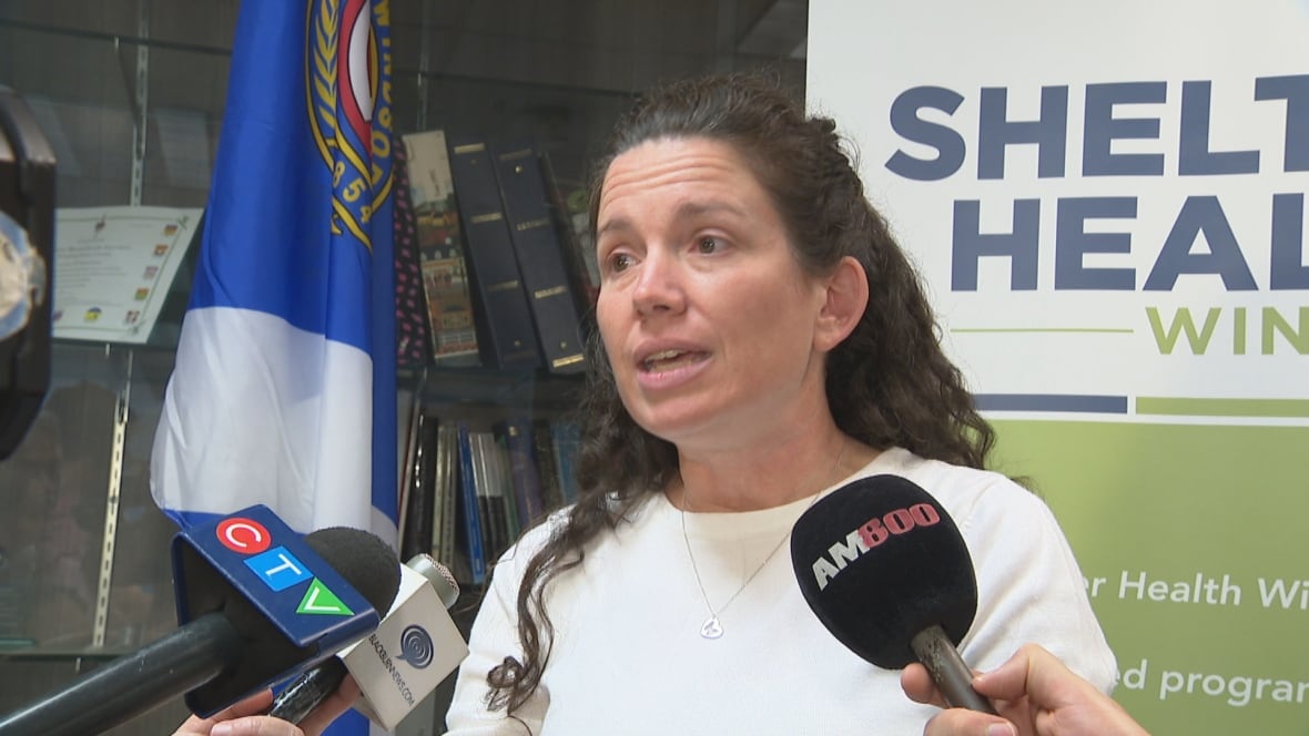 Close-up of Bondy surrounding by microphones.