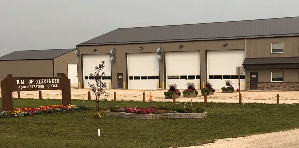 A brown building with white garage doors