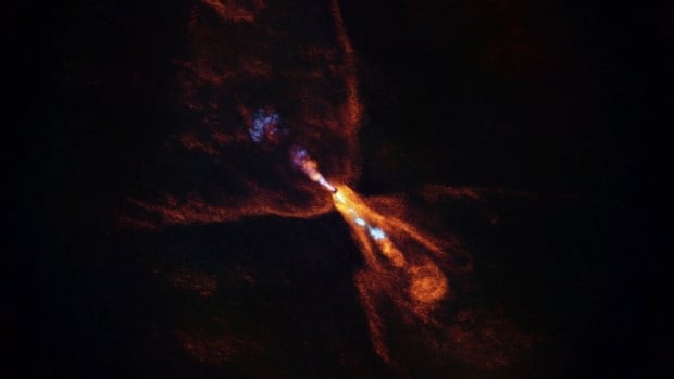 This image provided by the European Southern Observatory on Tuesday, July 15, 2025, shows HOPS-315, a baby star where astronomers have observed evidence for the earliest stages of planet formation. An explosion of orange light against a black background