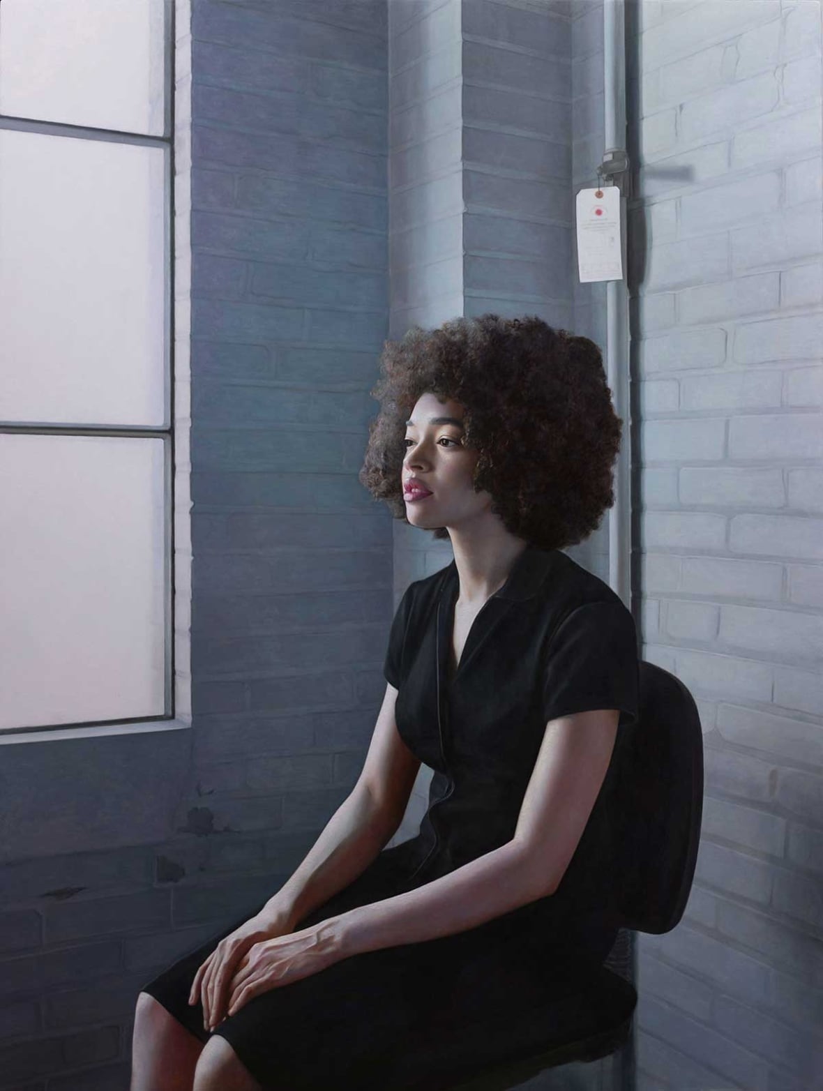 A woman sitting in an industrial loft space.