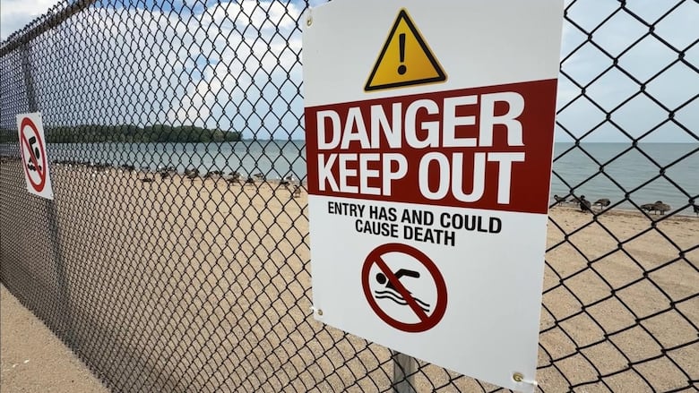 Signs at Sandpoint Beach tell people that swimming in the area could lead to death. 
