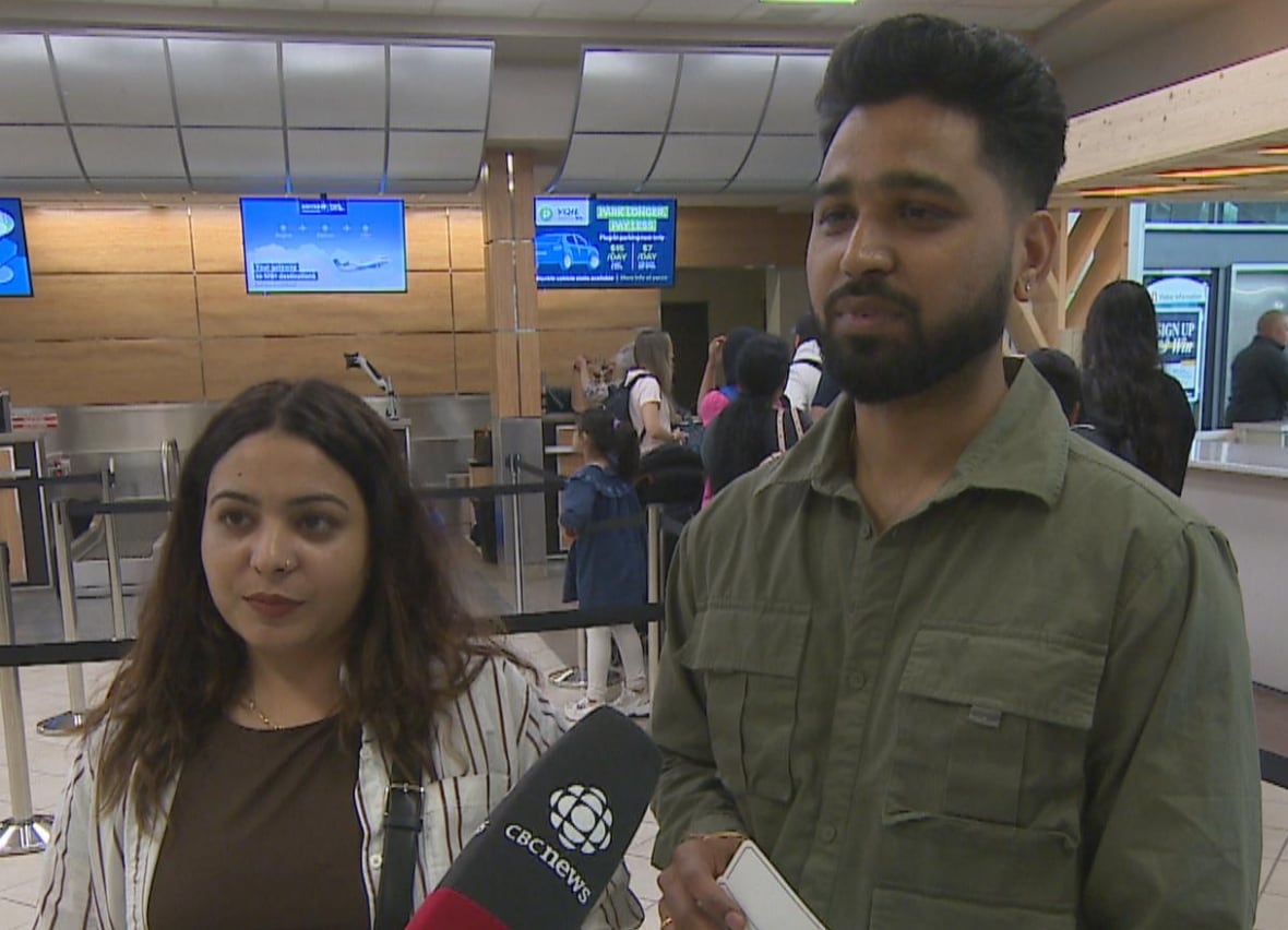 Karandeep Purba (left) and Gurpreet Purba stand in the YQR airport.