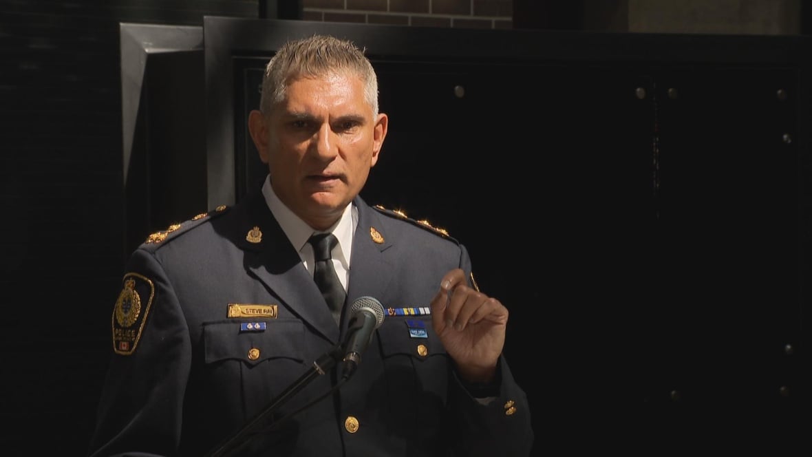 A police officer speaks at a podium.
