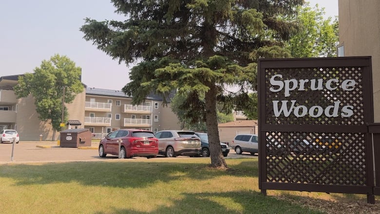 A sign outside an apartment complex reads "Spruce Woods."