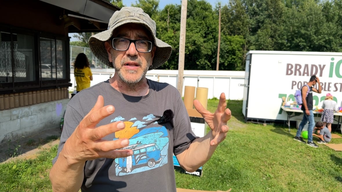 A mean with glasses who is wearing a bucket hat.