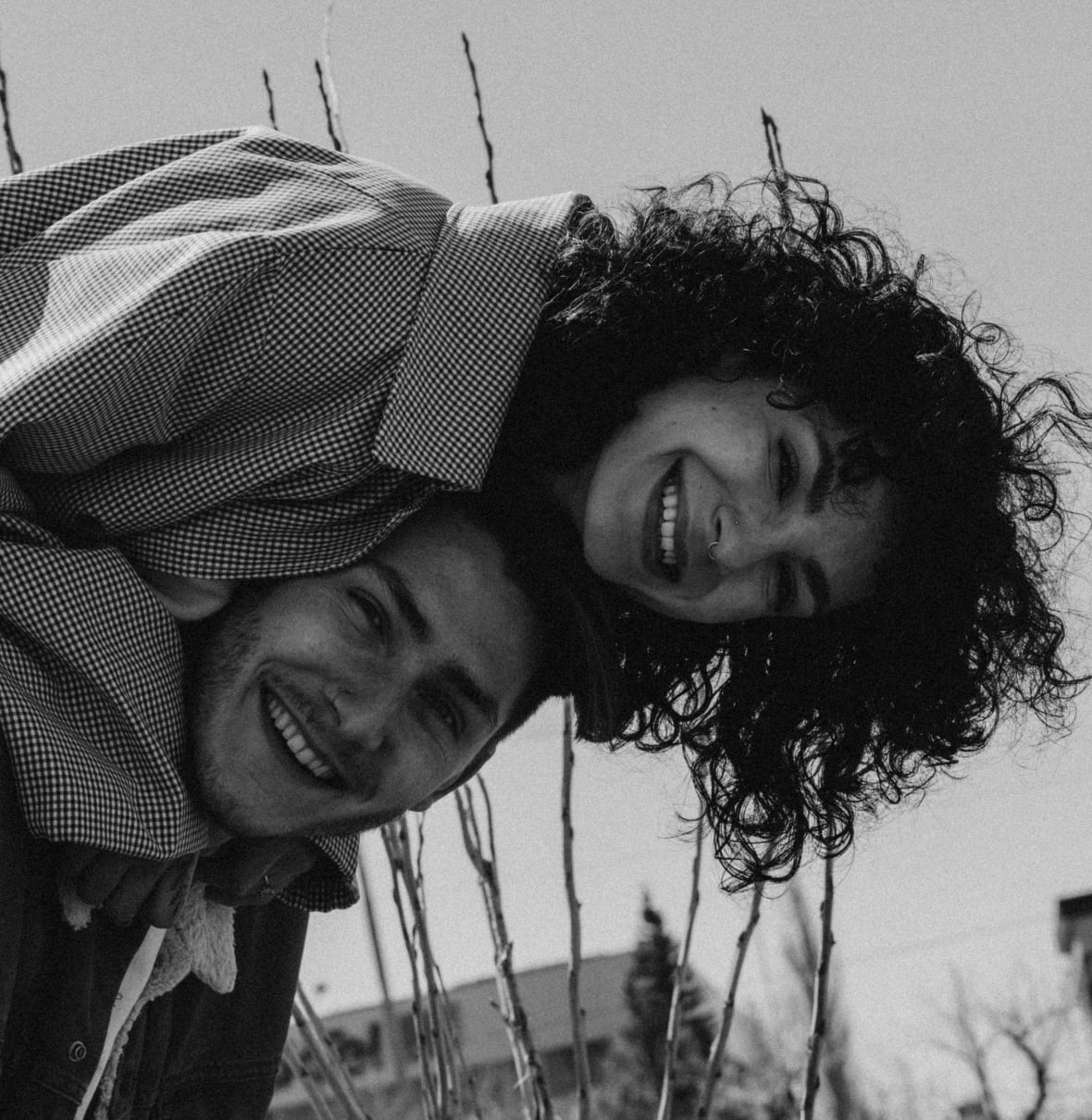 A young man piggybacks his wife. 
