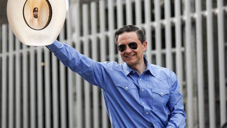 Conservative Leader Pierre Poilievre waves to the crowd as he rides in the Calgary Stampede parade in Calgary, Alta., Friday, July 4, 2025.