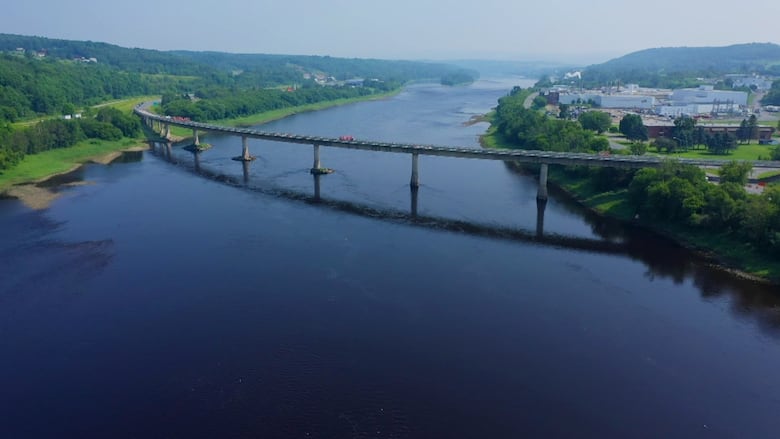 A drone image of a bridge over blue waters