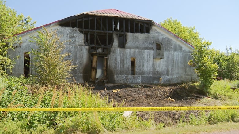 Building that looks like a barn with fire damage.