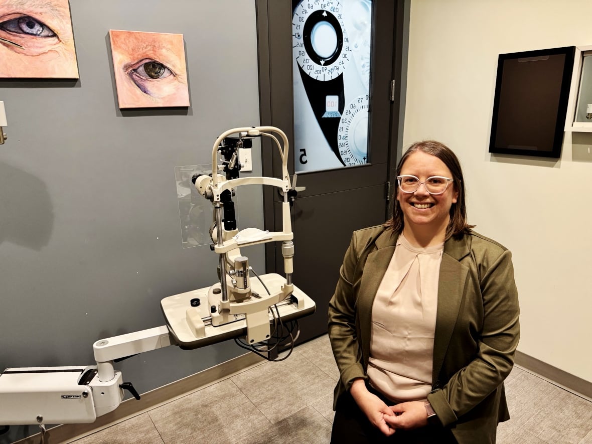 Person sitting and looking at the camera in an optometrist's office.