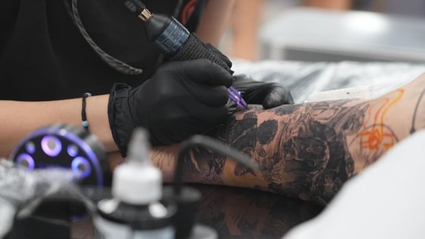 close up shot of a person with a tattoo sleeve getting a tattoo