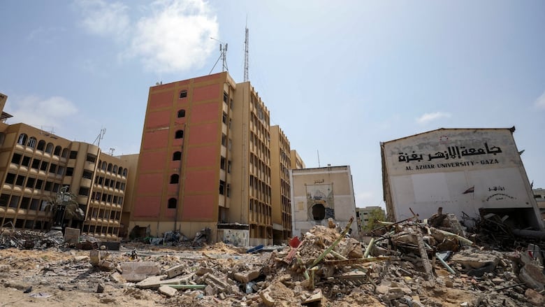 Destroyed university buildings. The name of a university is written in English and Arabic.