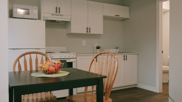 Inside a supportive housing unit built by Redwood Park Communities, in Simcoe County, Ont. The organization provides 'deeply subsidized' rental units, according to communications director Jennifer Van Gennip. A kitchen table with fruit bowl in a supportive housing building.