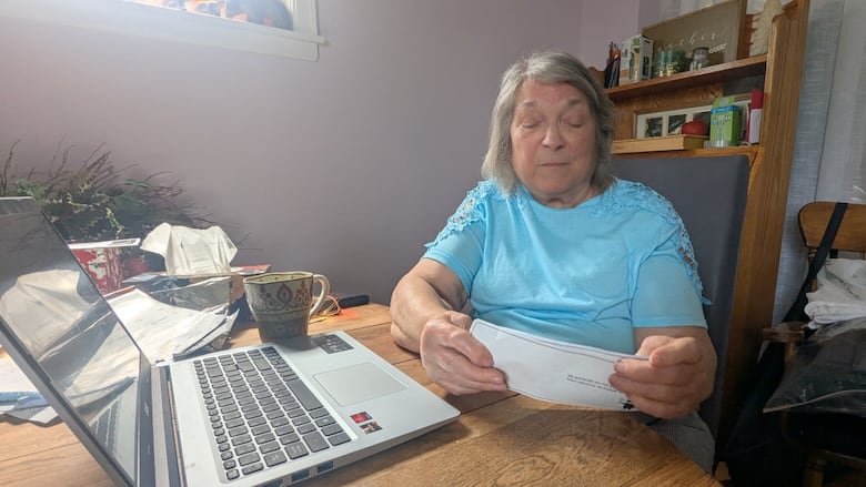 Carol Rogers, an 85-year-old from Sydney, N.S., looks over a boarding pass from her recent flight to Alberta in May for a family reunion. On her departing and return flights, Rogers says she was denied mobility supports that were requested as part of her flight booking.