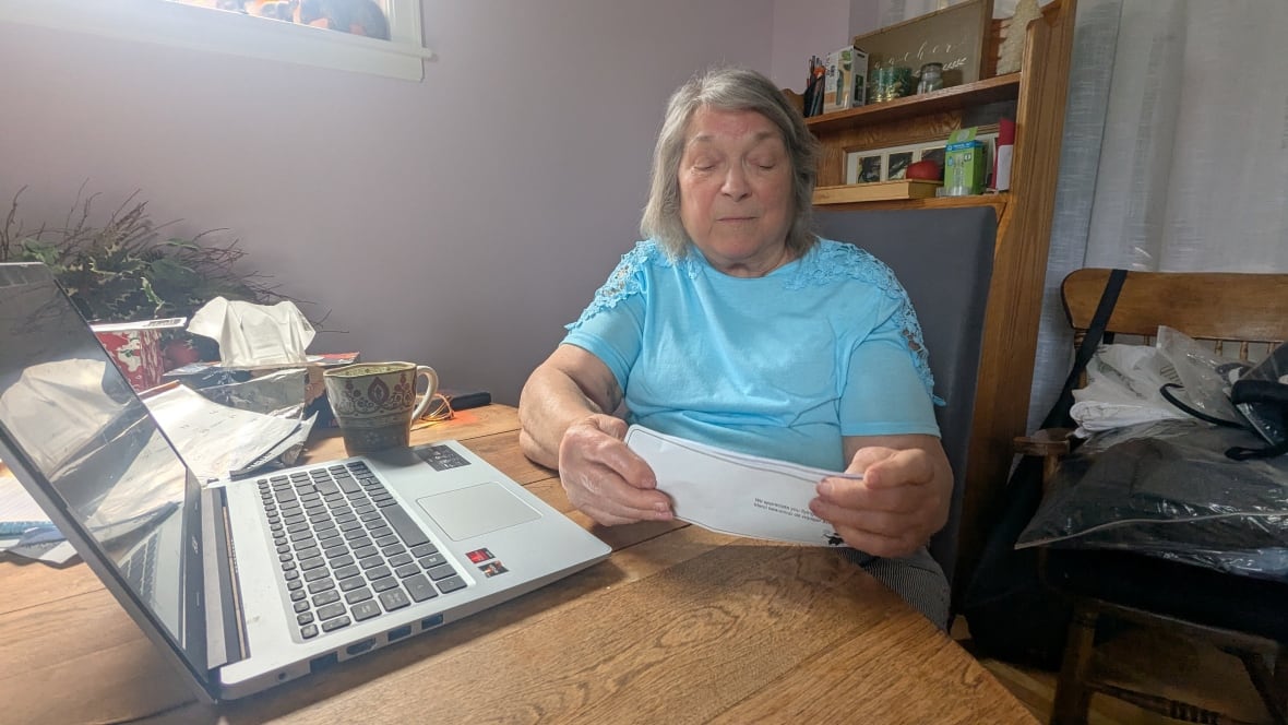 Carol Rogers, an 85-year-old from Sydney, N.S., looks over a boarding pass from her recent flight to Alberta in May for a family reunion. On her departing and return flights, Rogers says she was denied mobility supports that were requested as part of her flight booking.