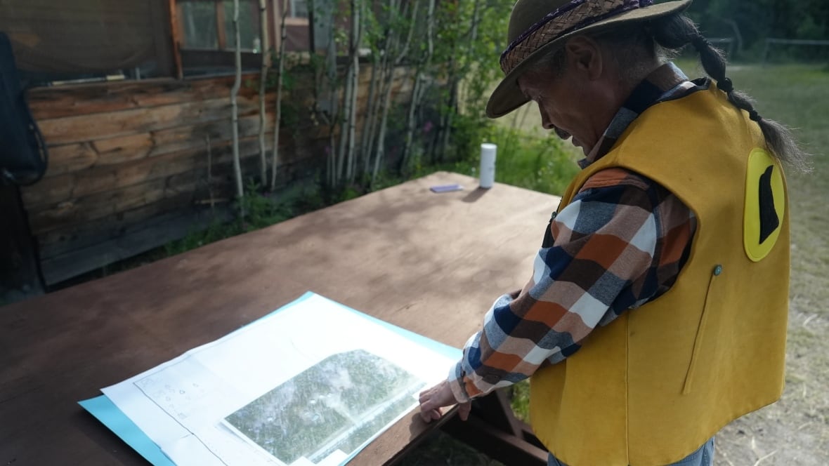 A man looking down at a map.