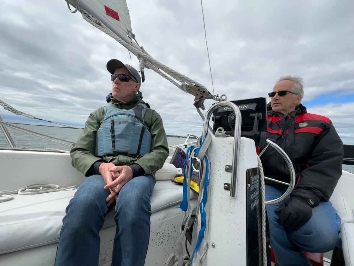 Two men sitting on a boat.