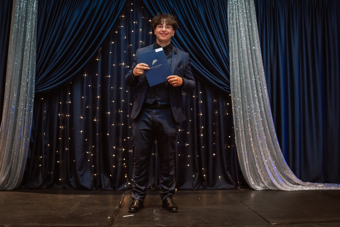 A young man wearing a suit at a ball