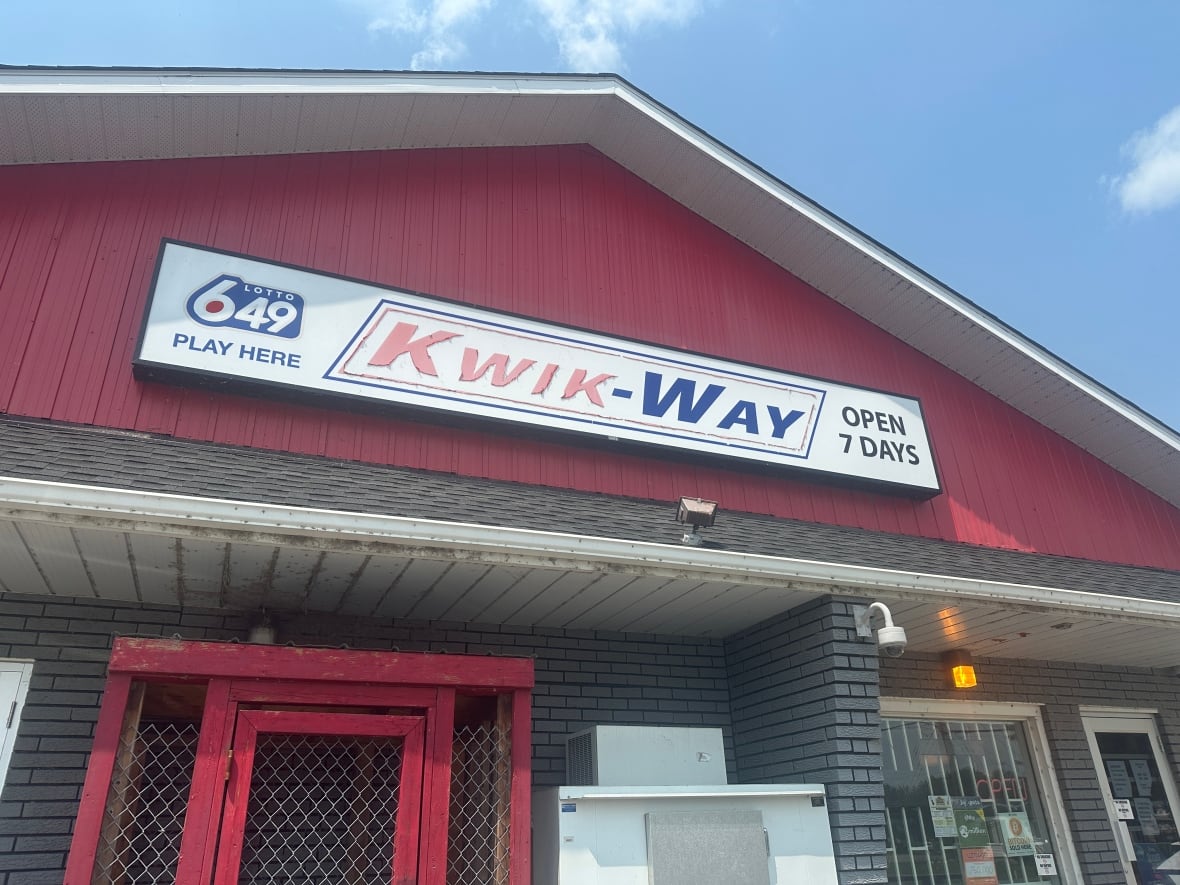 Photo of a building outdoors with the sign of the type of store it is in red and blue colours.