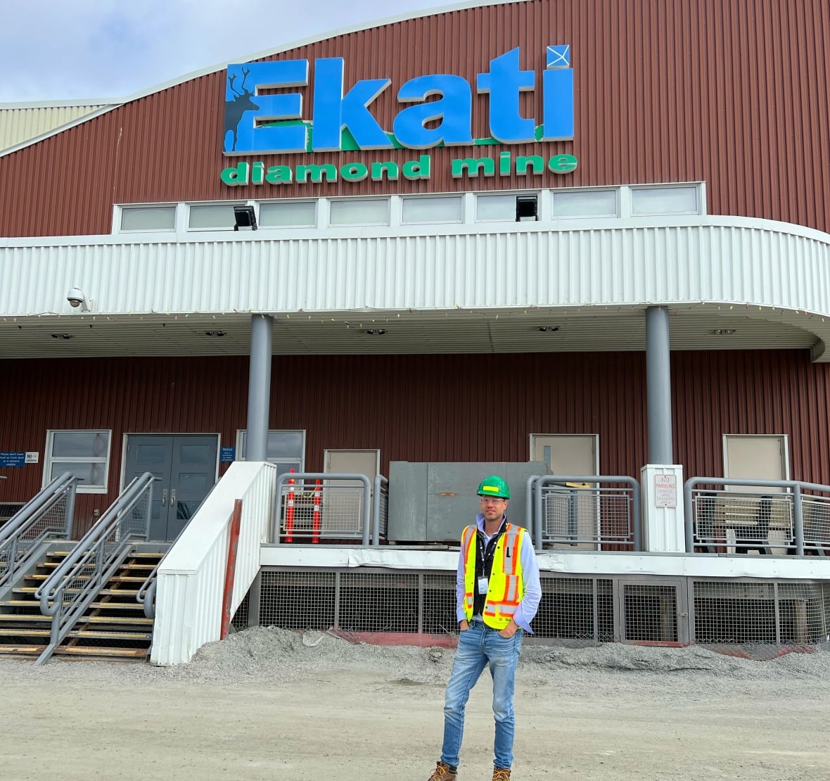 Paul Zimnisky, a diamond industry analyst, in a hard hat and safety vest outside a building at Ekati Diamond Mine.