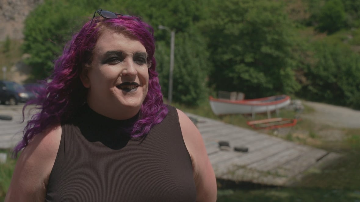 Goth woman with purple hair smiling