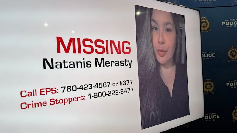 A screen with a woman's face that says "Missing: Natanis Merasty," with phone numbers for calling police or Crime Stoppers.