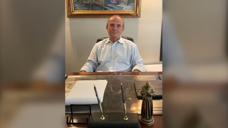 A man sits at a desk