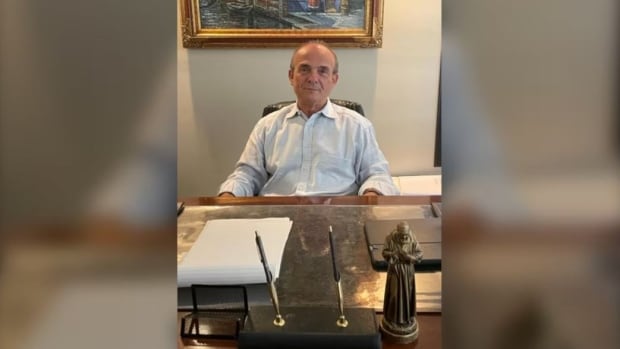 A man sits at a desk