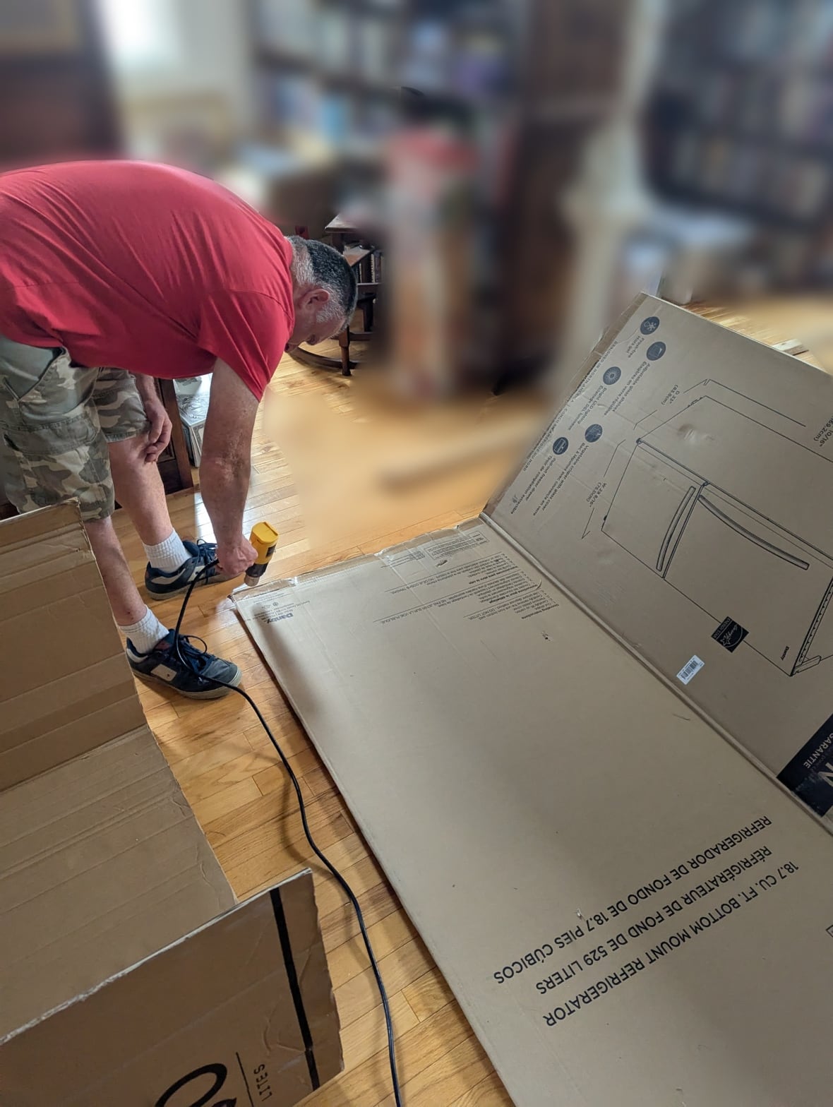 A man building a cardboard boat.