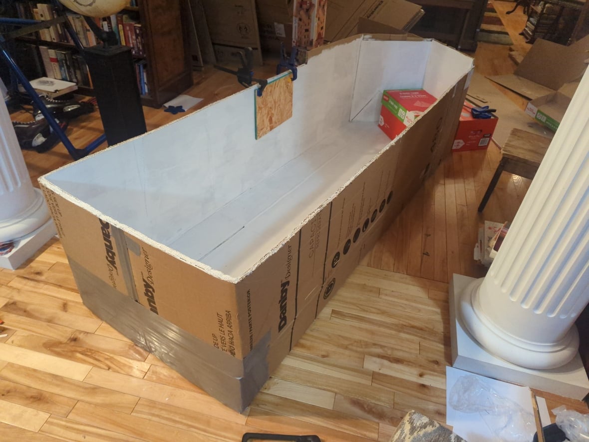An 8 feet long cardboard boat.