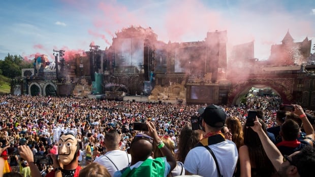Revellers attend an outdoor music festival.