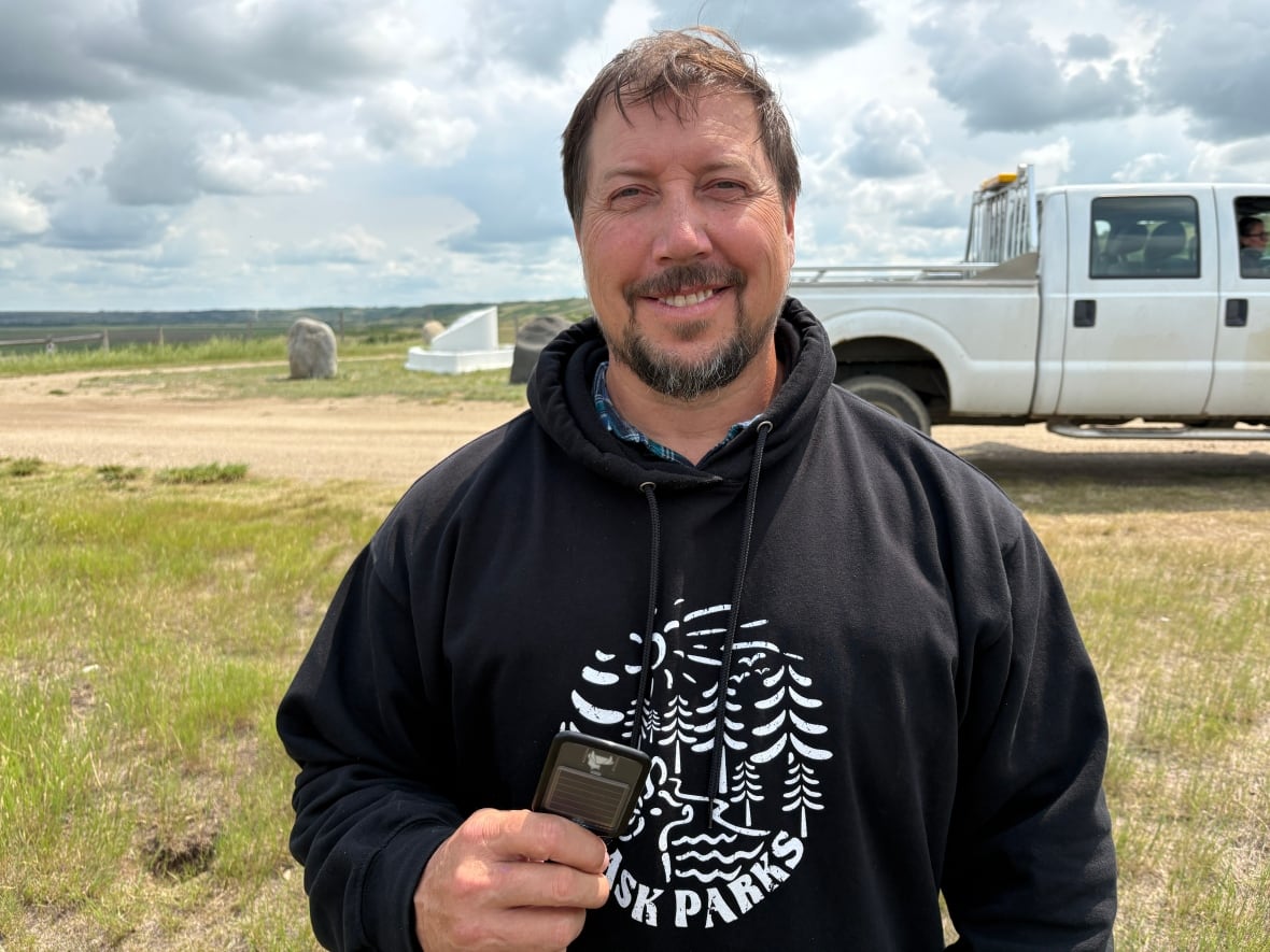 Dale Gross, a grasslands ecologist with Saskatchewan Parks, holds a GPS ear tag that is placed on bison at Buffalo Pound Provincial Park.