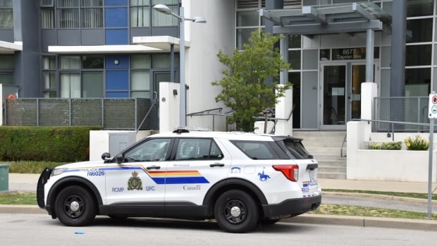 A Richmond RCMP SUV parked outside of a highrise tower