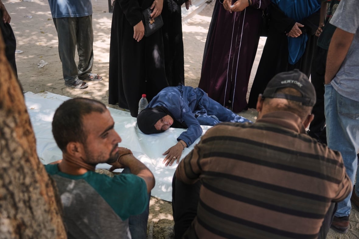 A woman cry with white plastic bodies.