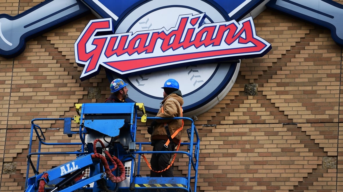Employee members change the board in a stadium.