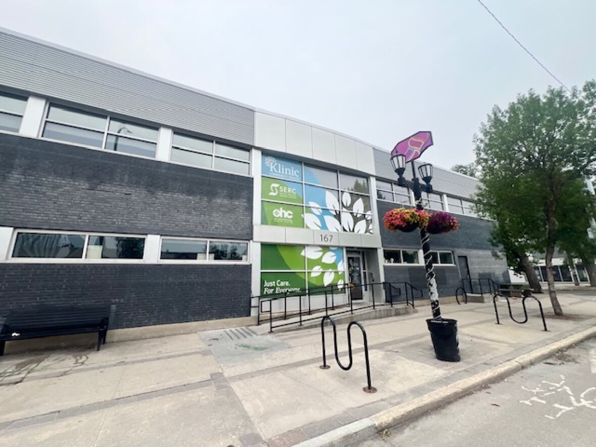 A building is seen with a pictures with signs outside.