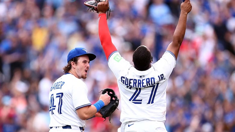 Addison Barger of the Toronto Blue Jays celebrates an 8-6 win over the visiting San Francisco Giants with teammate Vladimir Guerrero Jr. at Rogers Centre on July 19, 2025.