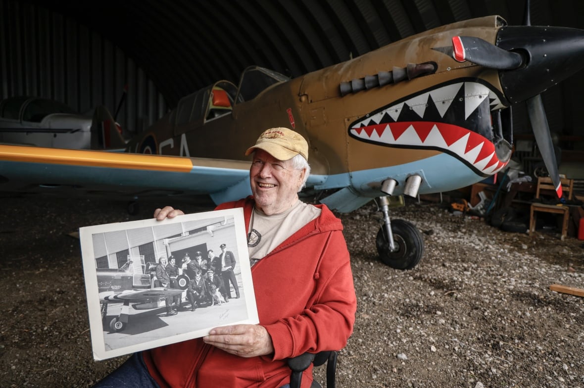 A man in front of a plane.