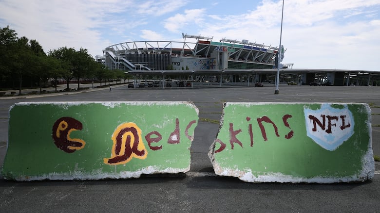 A concrete barrier in a stadium parking lot.