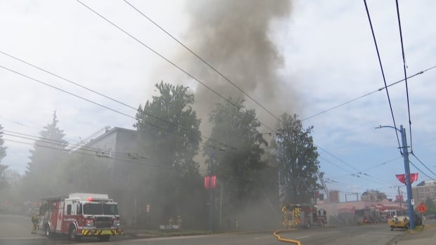 Firefighters battle heavy smoke and flames at a vacant building on East Hastings Street near Vernon Drive in Vancouver's Strathcona neighbourhood on Sunday.