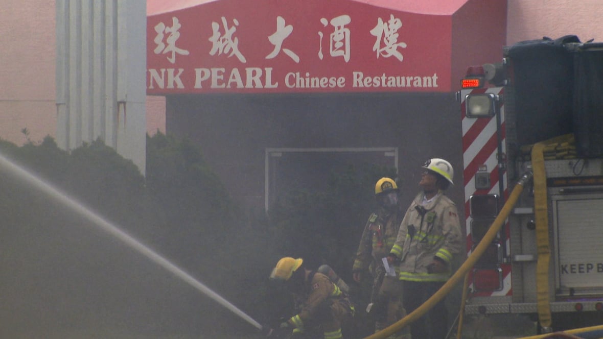 Firefighters work through thick smoke in front of the Pink Pearl Chinese Restaurant as they battle a blaze in the neighbouring vacant building.