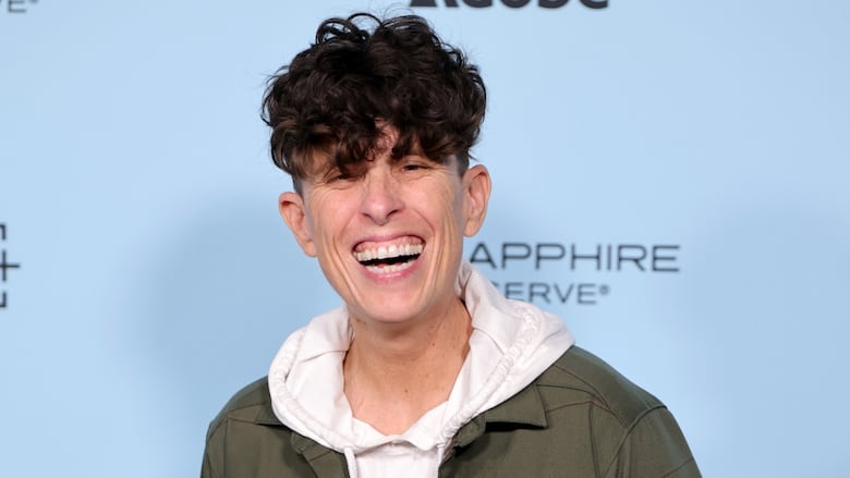 A person gives a huge smile to the camera.