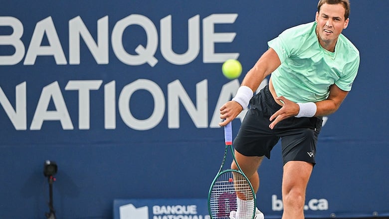 Canadian men’s tennis player Vasek Pospisil plays a shot to Sebastian Korda of the United States during their first-round match at the National Bank Open tournament in Montreal on August 7, 2024.