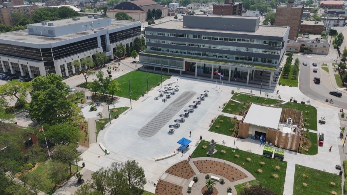 The photo shows Windsor's new ice rink (and splash pad) accompanied by public restrooms, added trees and greenery, with Windsor city hall in the background.