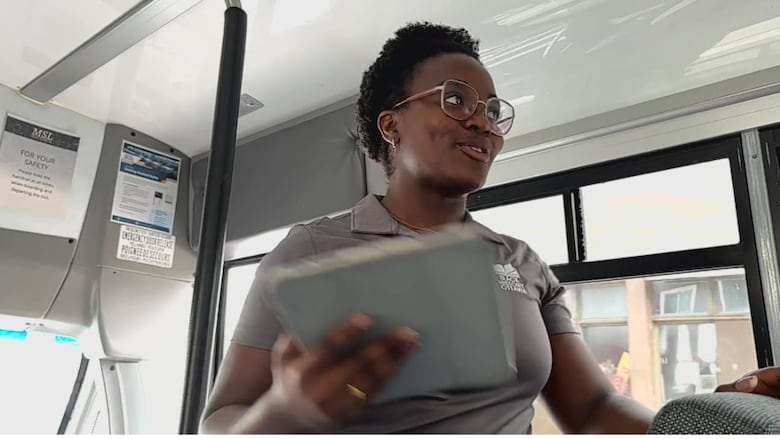 A woman leads a bus tour.
