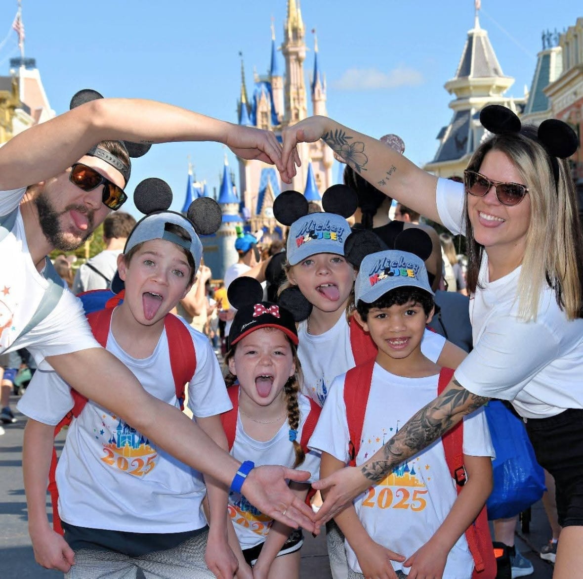 A family posing at a Walt Disney resort.