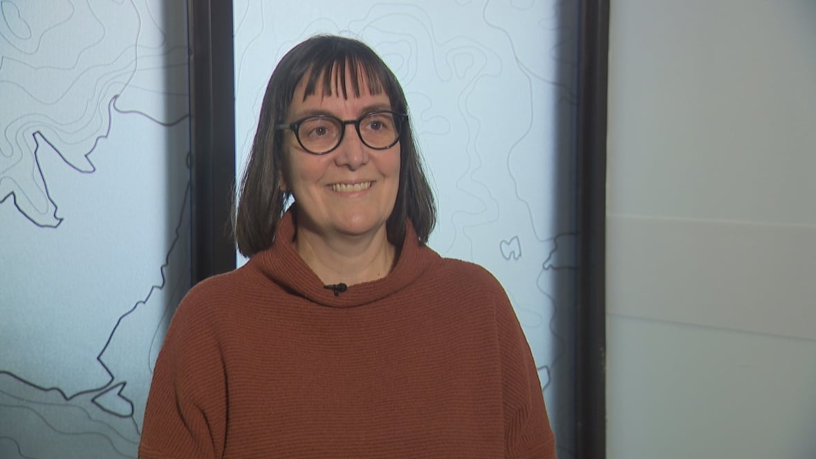 A portrait of a woman wearing glasses.