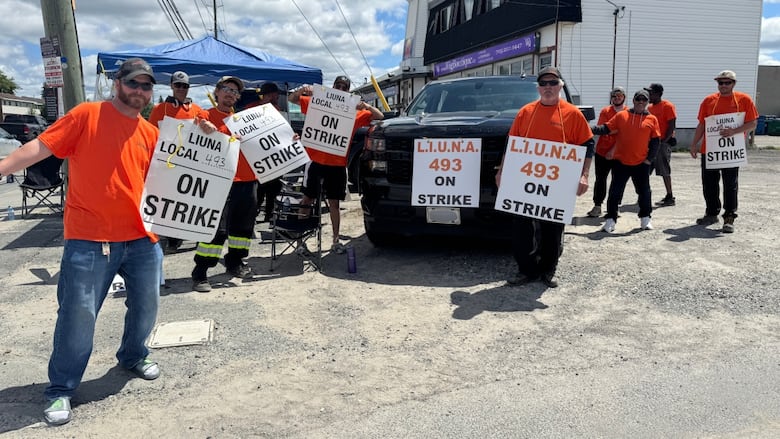 Men on picket line on strike.