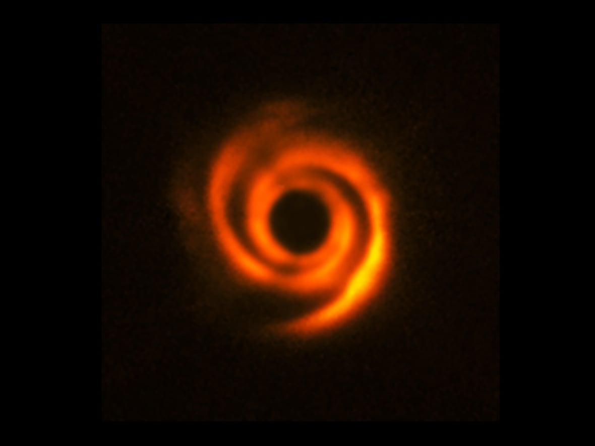 A bright orange and yellow swirl with a black background.